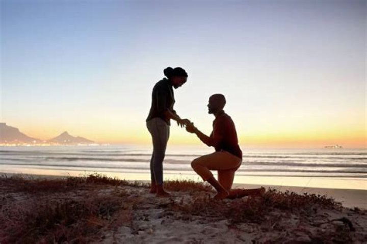 Watch The Moment A Lady Went On Her Knees To Propose To Her Boyfriend At His Workplace (VIDEO)
